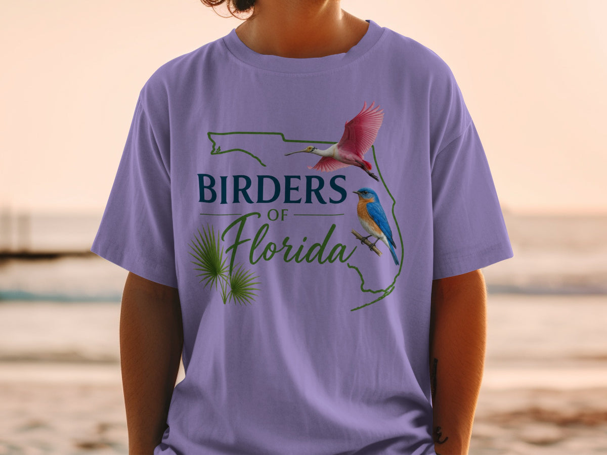 Purple t-shirt with "Birders of Florida" text, a roseate spoonbill, and a bluebird.