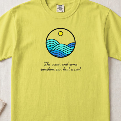 Yellow crewneck t-shirt featuring a circular ocean graphic and the text "The ocean and some sunshine can heal a soul."