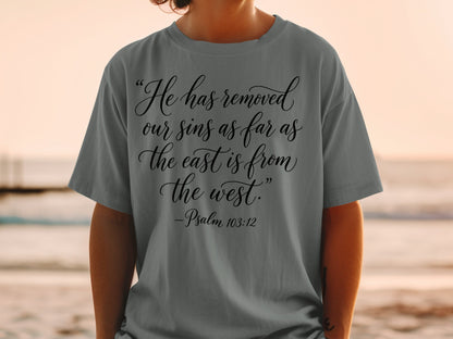 Gray t-shirt with text "He has removed our sins as far as the east is from the west. -Psalm 103:12".