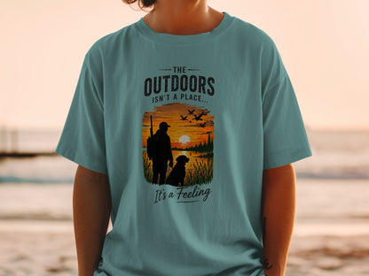 T-shirt graphic with text "The Outdoors Isn't a Place... It's a Feeling."