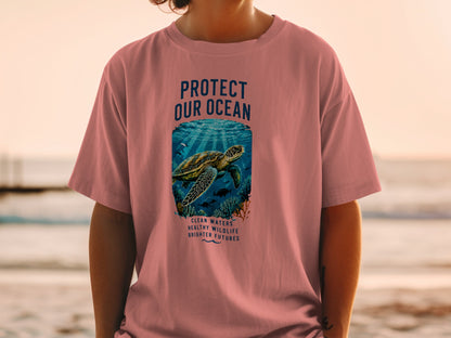 Pink t-shirt with "PROTECT OUR OCEAN" text, sea turtle, and marine life graphic.