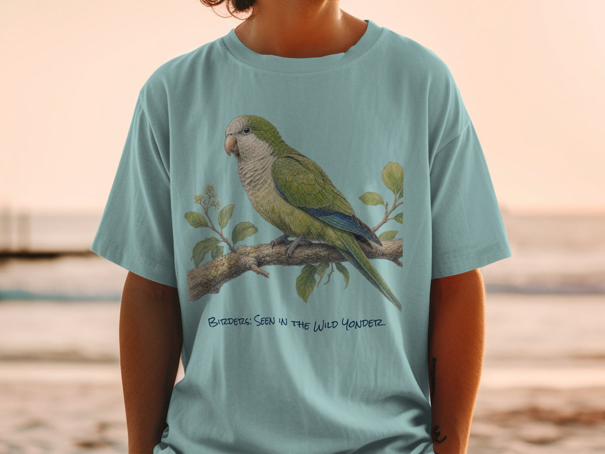 Light blue t-shirt with green parrot on branch illustration and text "BIRDS: SEEN IN THE WILD YONDER".