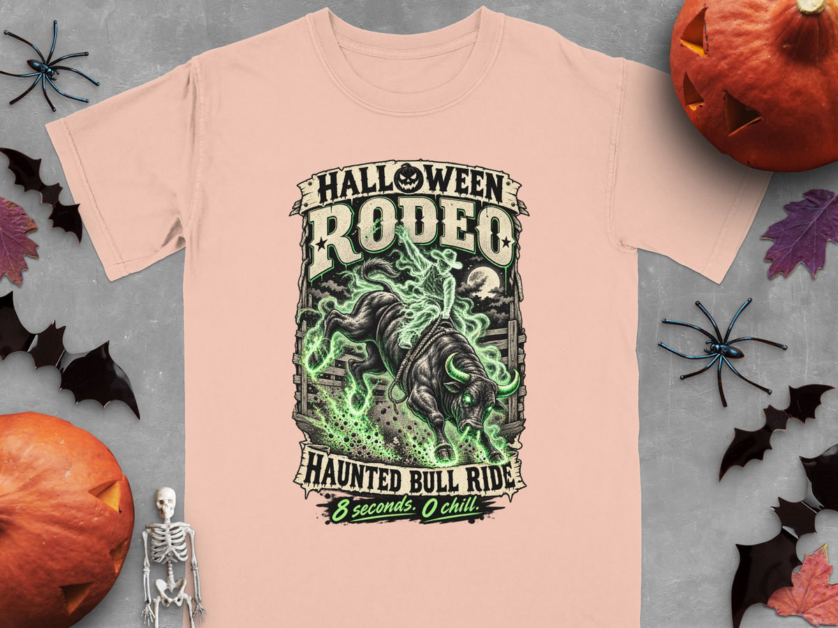 Light pink t-shirt with "Halloween Rodeo Haunted Bull Ride" graphic.