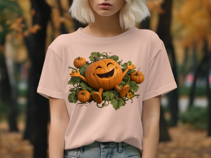 Pink t-shirt featuring a cartoon pumpkin with outstretched arms and legs surrounded by leaves.