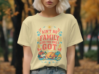 Yellow t-shirt with "Ain't no family like the one I got" and Thanksgiving food.