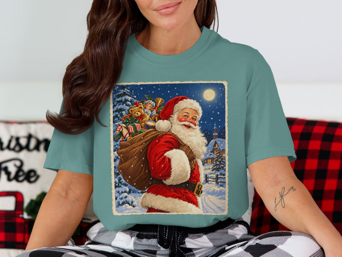 Santa Claus carries a sack of gifts through a snowy village under a full moon.