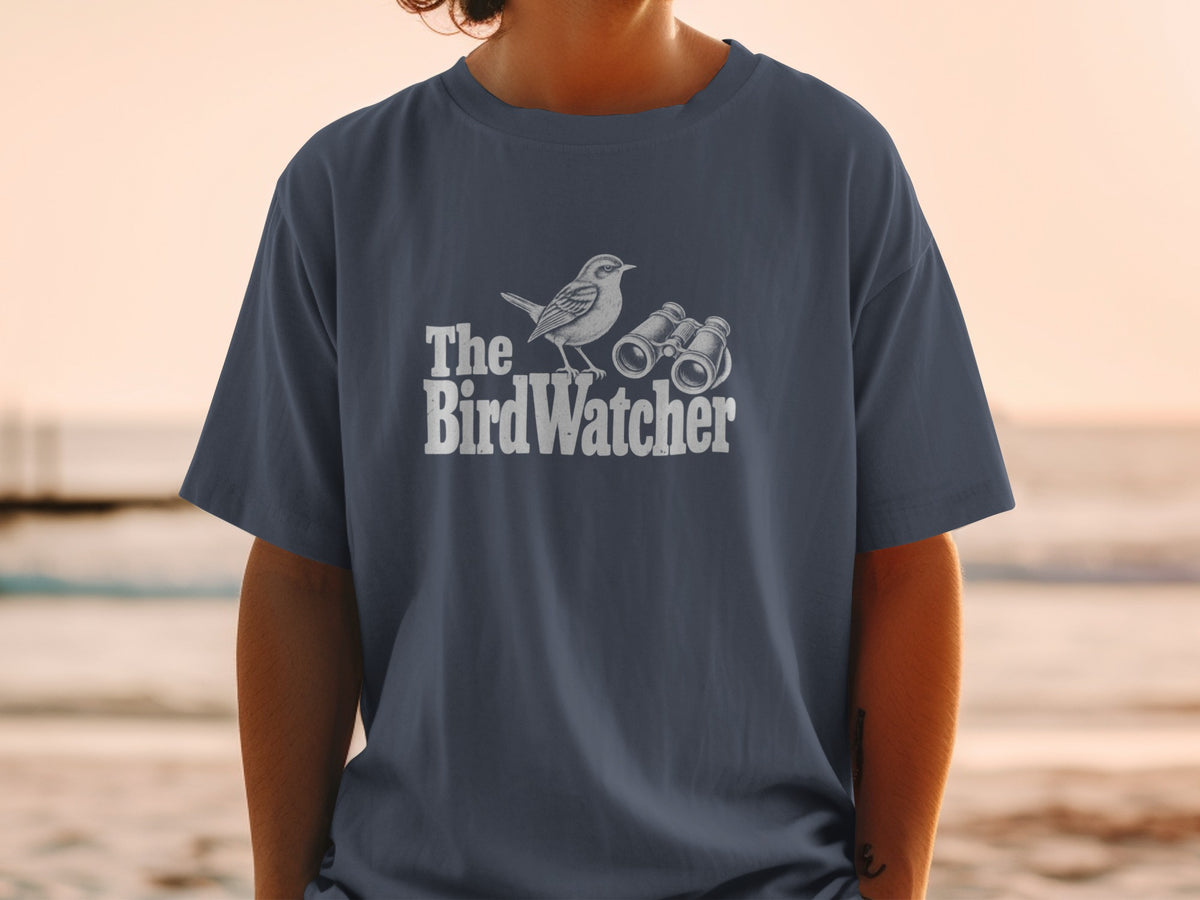 Dark blue t-shirt with white text and illustration of a bird and binoculars.