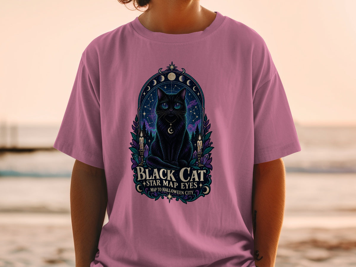 T-shirt with a mystical black cat graphic, stars, moons, and text: "Black Cat Star Map Eyes Map to Halloween City".