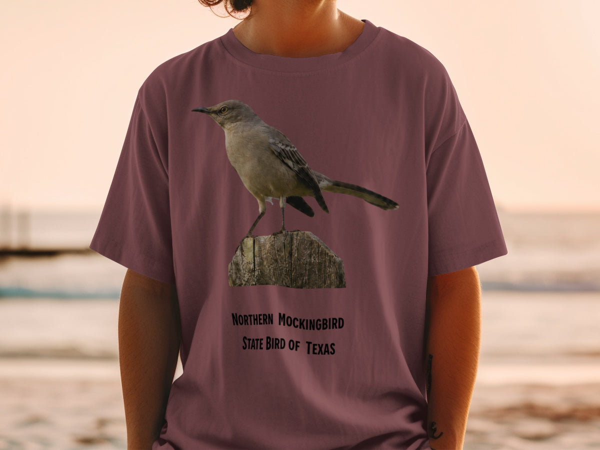 Northern Mockingbird, State Bird of Texas graphic on a maroon t-shirt.