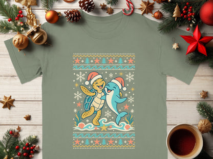 Green t-shirt with cartoon turtle and dolphin wearing Santa hats.