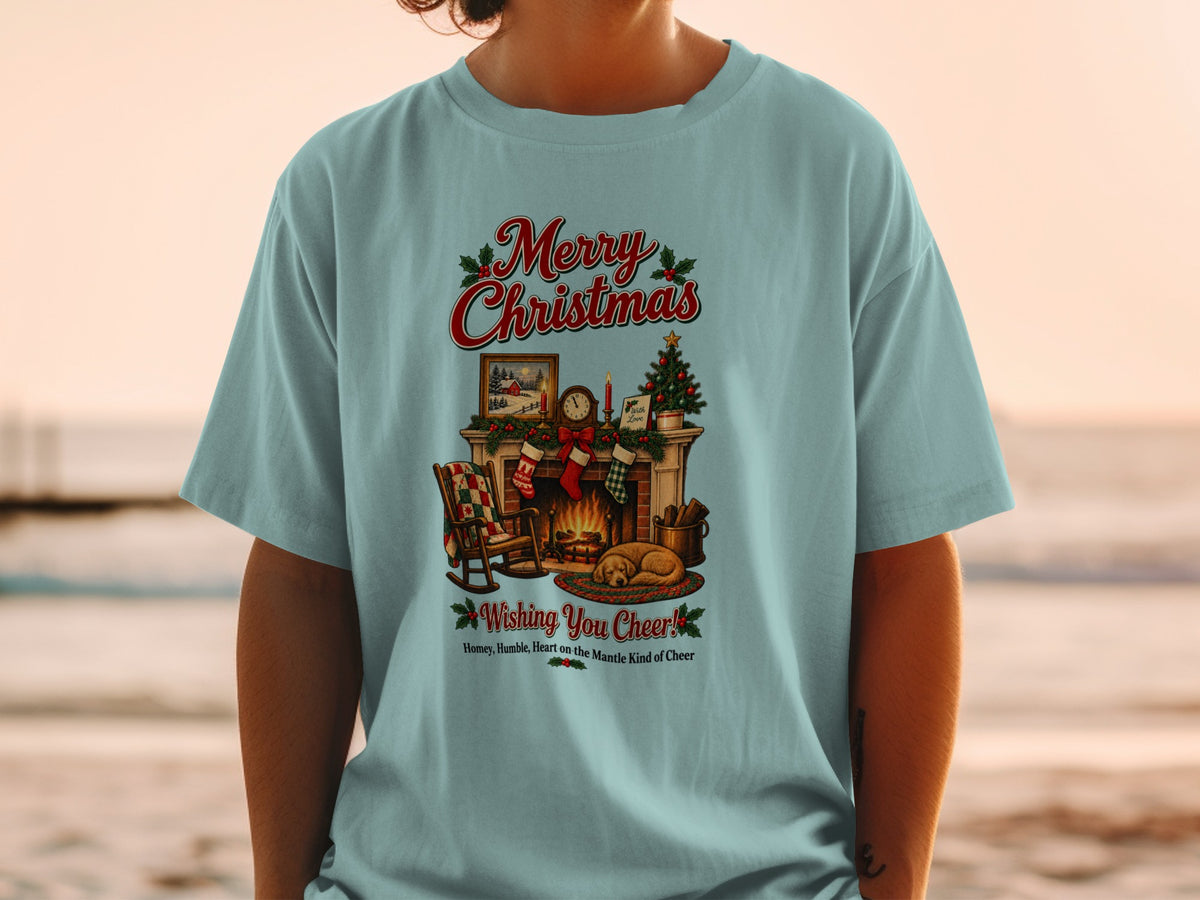 Light blue t-shirt with Merry Christmas design featuring a fireplace, tree, and sleeping dog.