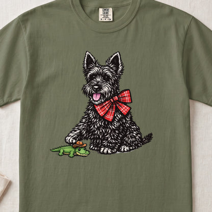 Scottish terrier with a red plaid bow ties next to a crocodile in a cowboy hat.
