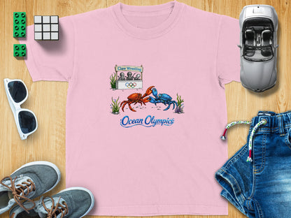 Pink t-shirt with graphic of crabs wrestling at the Ocean Olympics.