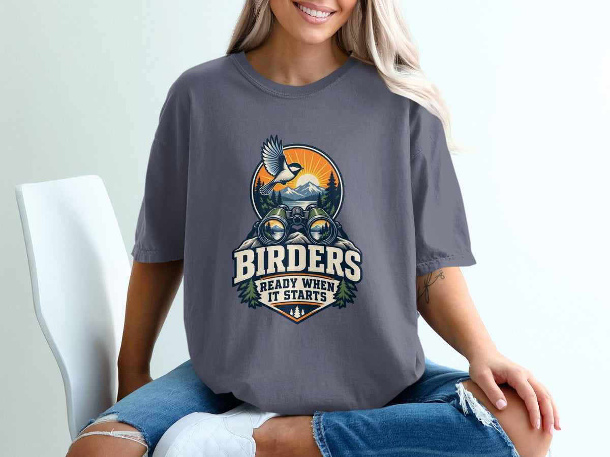 Shirt with bird, binoculars, mountains, and text "BIRDERS READY WHEN IT STARTS".
