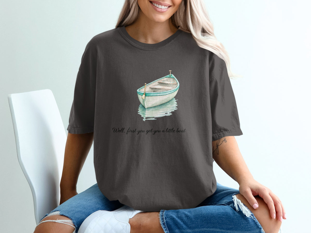 Dark gray t-shirt with watercolor boat graphic and text.