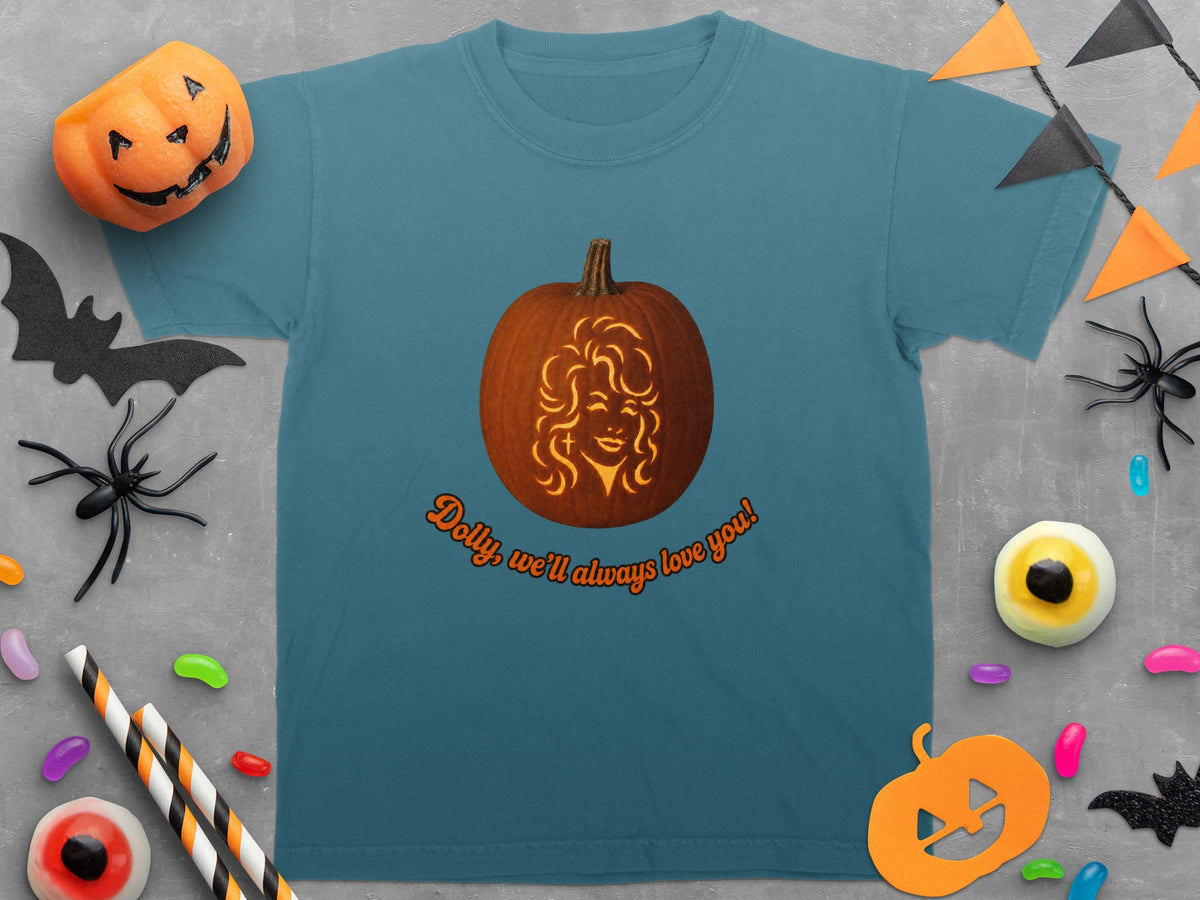 Teal t-shirt with a pumpkin carving of Dolly Parton and the text "Dolly, we'll always love you!".