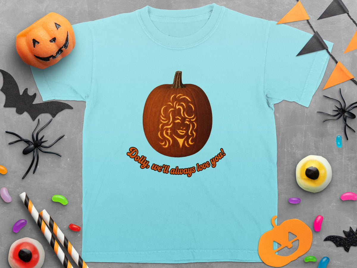 Light blue t-shirt with a carved pumpkin featuring Dolly Parton's face and text.