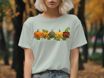 T-shirt with row of five carved jack-o'-lanterns and one wearing a striped hat.