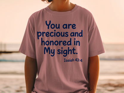 Pink t-shirt with blue text "You are precious and honored in My sight. Isaiah 43:4".