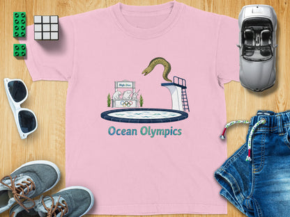Pink t-shirt with a graphic of a high dive and an eel, featuring the text "Ocean Olympics".