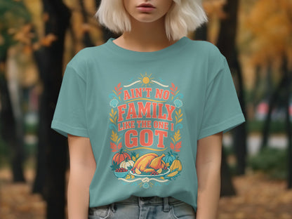 Teal t-shirt with "Ain't No Family Like the One I Got" text and Thanksgiving food graphics.