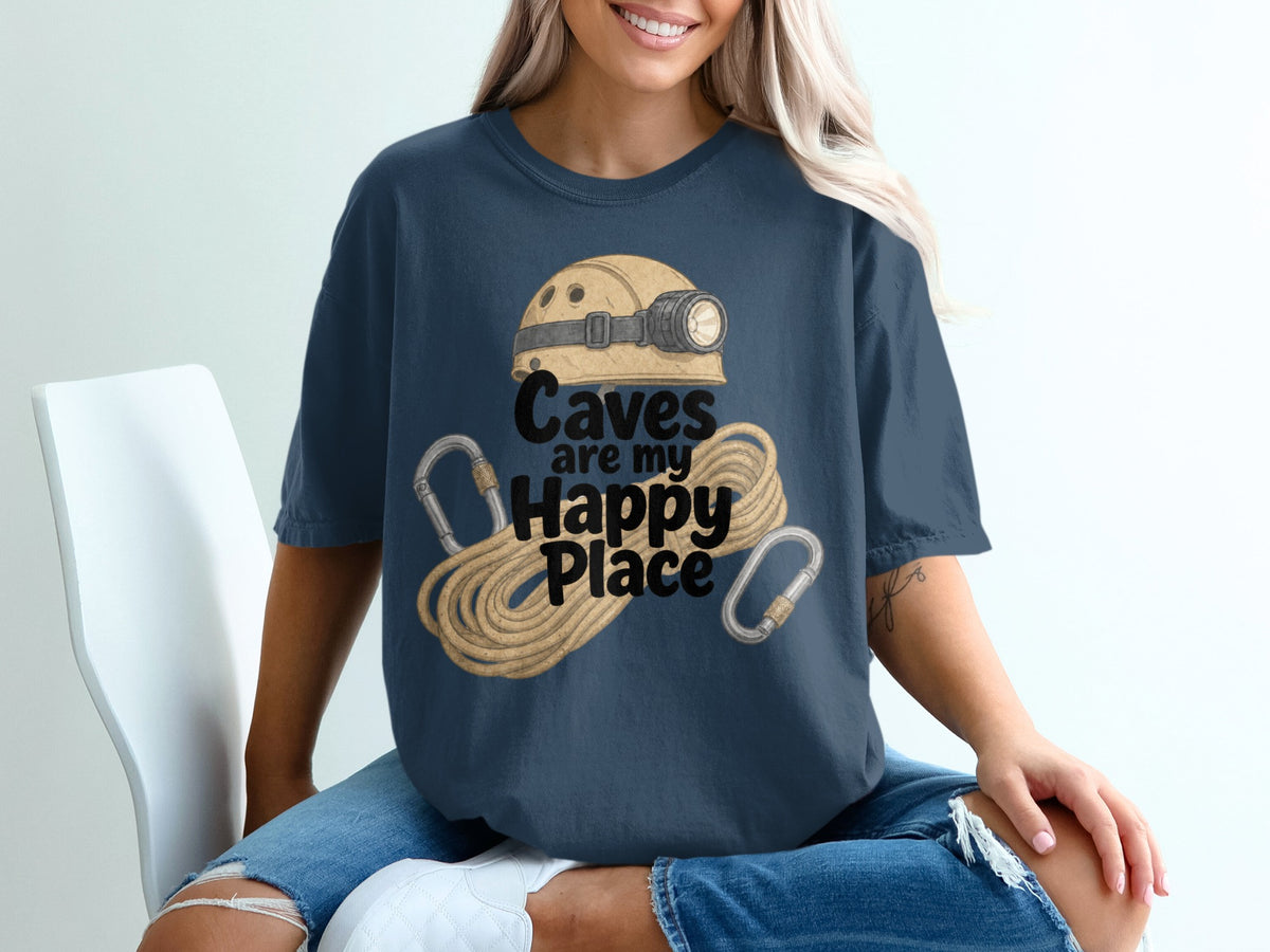 Dark blue t-shirt with illustration of spelunking helmet, rope, and carabiners, text "Caves are my Happy Place".