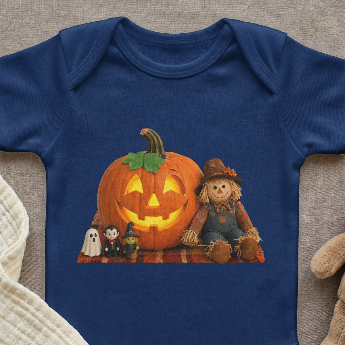 Dark blue baby bodysuit with a Halloween graphic of a jack-o'-lantern and characters.