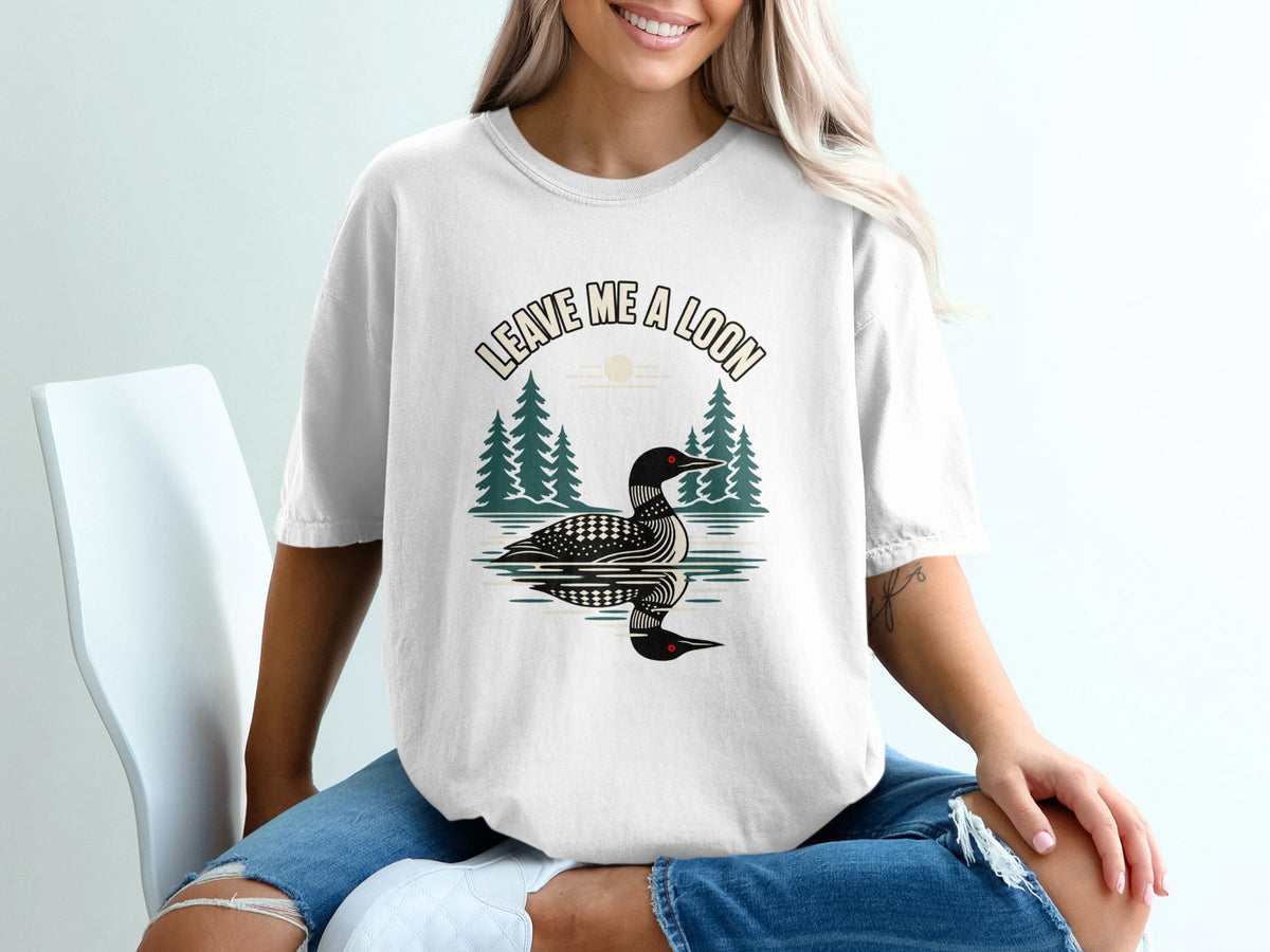 White t-shirt with a loon graphic and text "Leave Me A Loon".