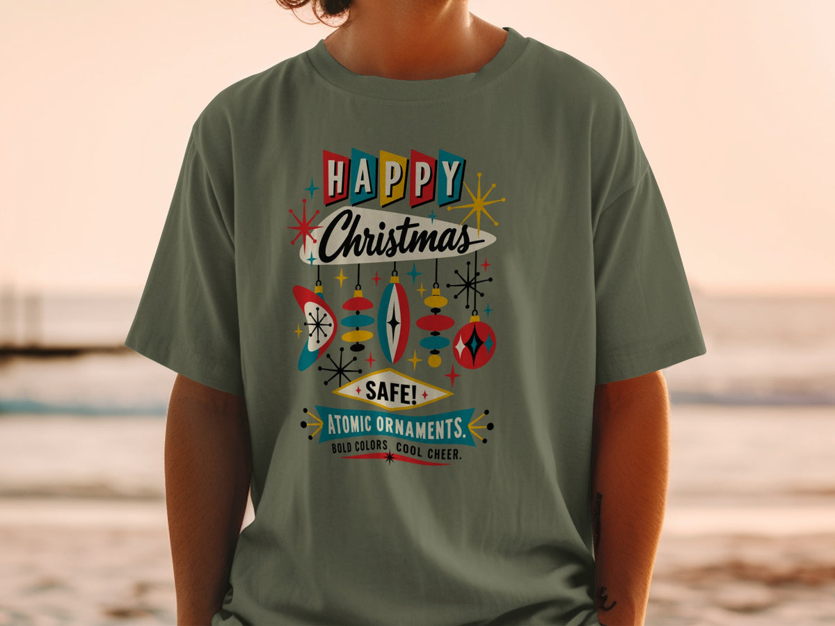 Green t-shirt with "Happy Christmas Atomic Ornaments" text and retro ornaments.