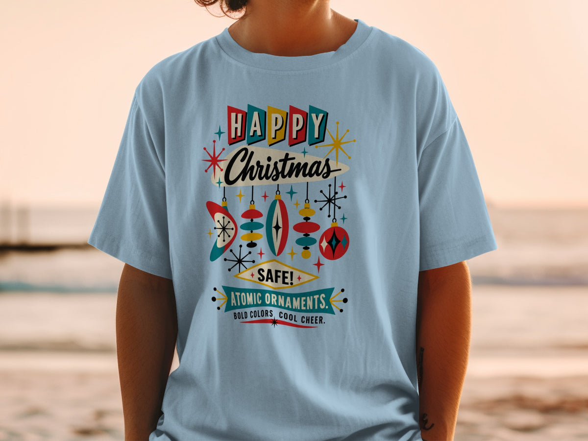 Light blue t-shirt with retro "Happy Christmas" and "Atomic Ornaments" text and graphics.
