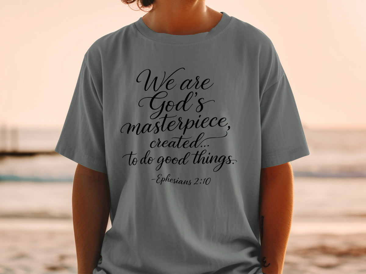 Gray t-shirt with black text "We are God's masterpiece, created... to do good things. -Ephesians 2:10".