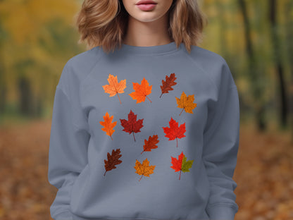 Grey sweatshirt featuring a scattered pattern of colorful autumn leaves.