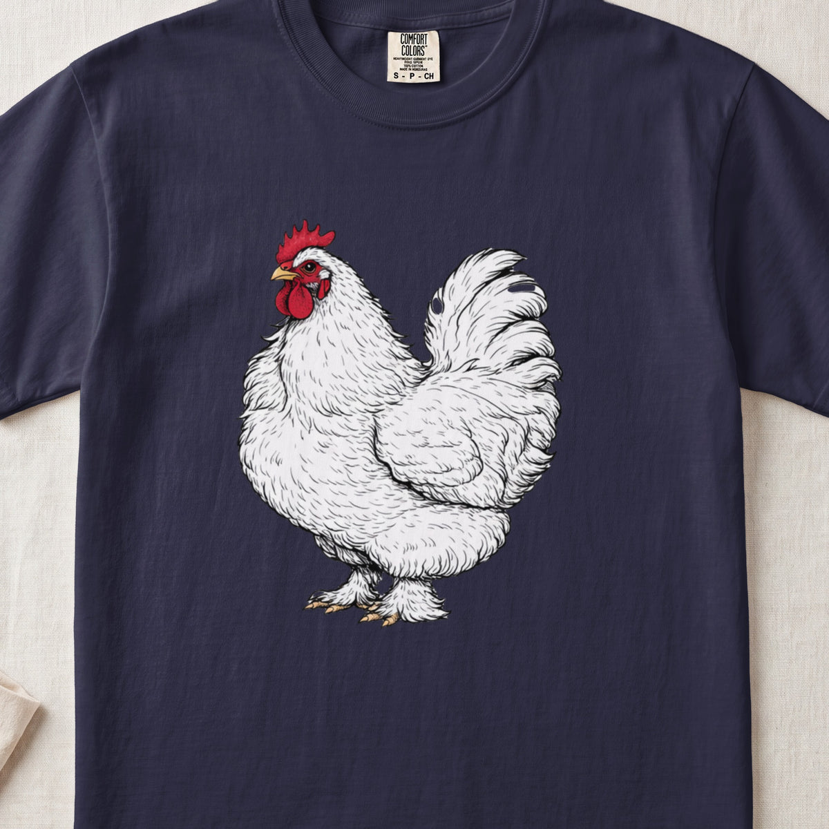 A navy blue t-shirt featuring a detailed white rooster illustration on the front.
