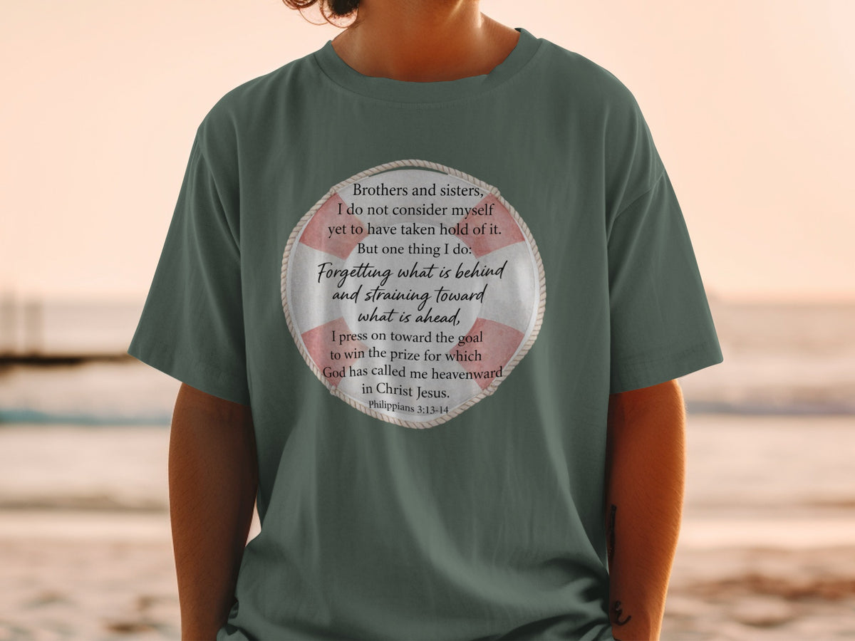 Green t-shirt with a circular graphic containing text from Philippians 3:13-14.