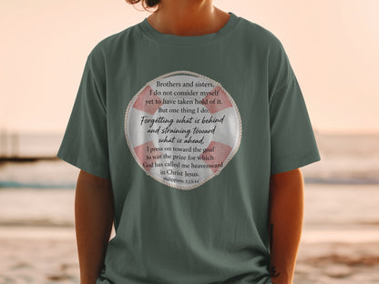 Green t-shirt with a circular graphic containing text from Philippians 3:13-14.