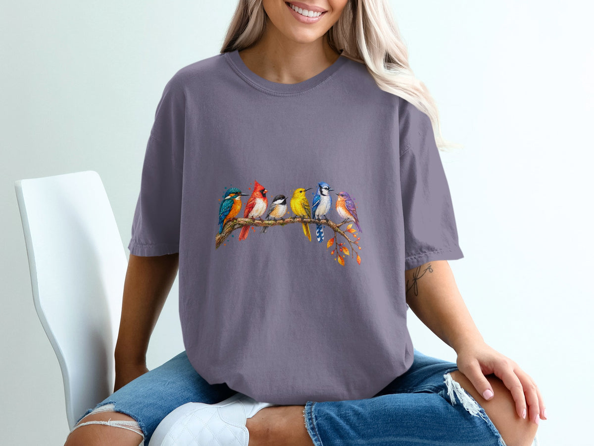 T-shirt with colorful birds perched on a branch with autumn leaves.