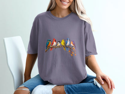T-shirt with colorful birds perched on a branch with autumn leaves.