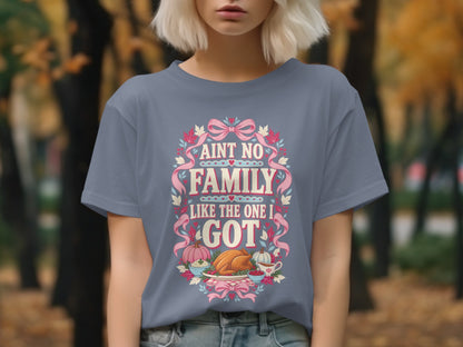 Grey t-shirt with text "AINT NO FAMILY LIKE THE ONE I GOT" and Thanksgiving dinner illustration.