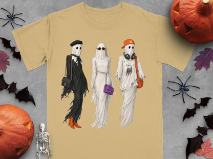 T-shirt with three ghosts in Halloween costumes, accessorized with purses and hats.