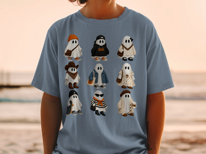 Nine illustrated ghosts in various outfits are printed on a slate blue t-shirt.