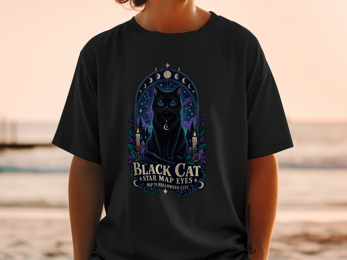 Black cat with star map eyes and crescent moon necklace, text says "Black Cat Star Map Eyes Map to Halloween City".
