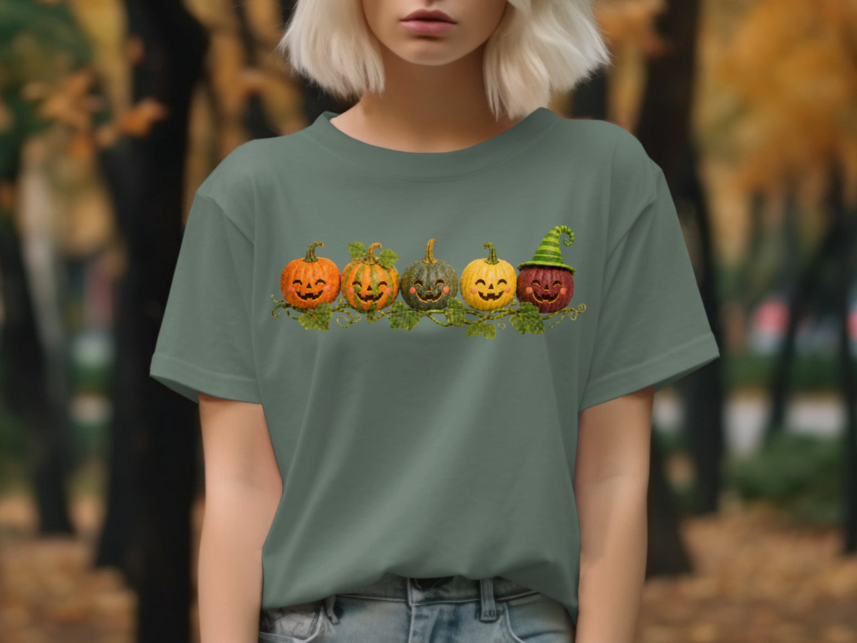 Green t-shirt with a graphic of five smiling jack-o'-lanterns with vines.
