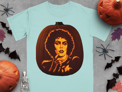 Light blue t-shirt featuring a carved pumpkin graphic of Frank-N-Furter, surrounded by Halloween decorations on gray wood.
