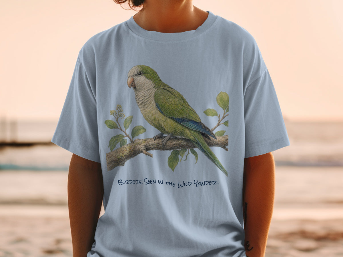 Light blue t-shirt with illustration of a green parrot on a branch and text "BIRDER'S: SEEN IN THE WILD YONDER".