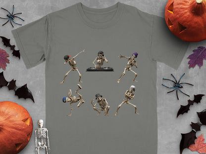 Six dancing skeletons, one DJing, on a grey t-shirt with Halloween decor.