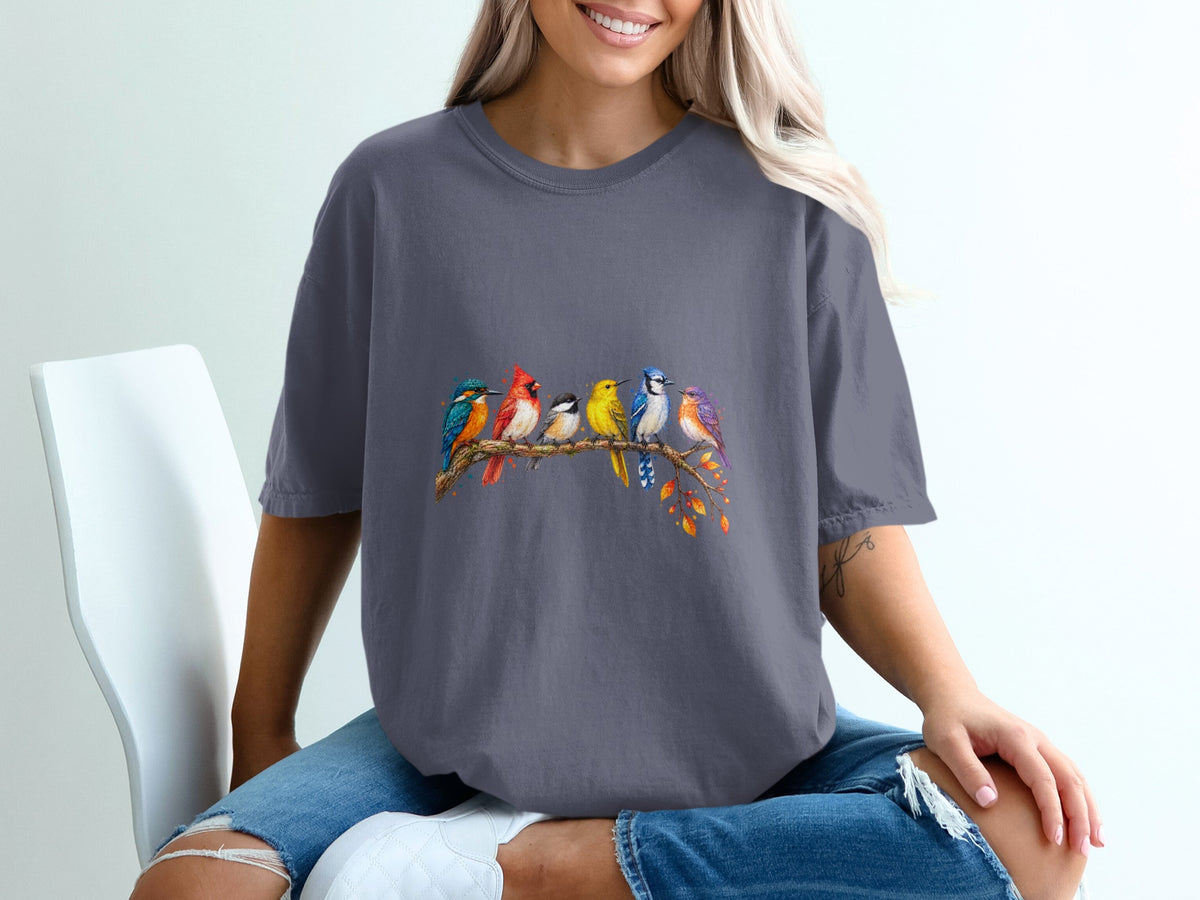 Graphic t-shirt with watercolor birds perched on a branch with autumn leaves.