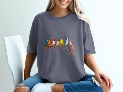 Graphic t-shirt with watercolor birds perched on a branch with autumn leaves.