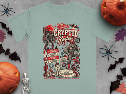 Cryptid Rodeo t-shirt design with Bigfoot, Mothman, Yeti, and alien spacecraft.