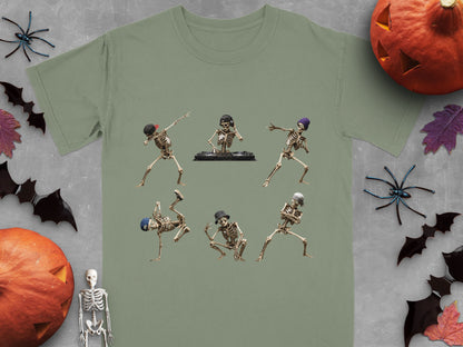 Six dancing skeletons, one DJing, on a sage green t-shirt.