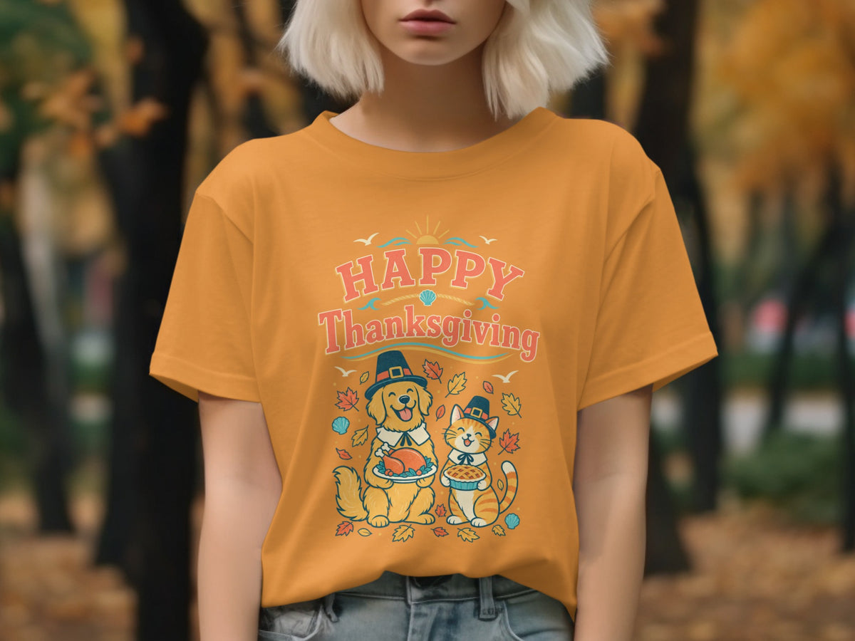 Orange t-shirt with a dog holding turkey and cat holding pie, saying "Happy Thanksgiving".